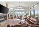 Inviting living room with a fireplace, comfortable seating, and stunning water views at 5287 61St S Ave, St Petersburg, FL 33715