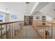 Open loft area with wooden railings, city views, and built-in bookshelves at 5287 61St S Ave, St Petersburg, FL 33715