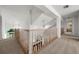 Bright loft area with wooden railings, carpet, and a clear view of the entry below at 5287 61St S Ave, St Petersburg, FL 33715