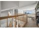 Open loft area with wooden railings, city views, and built-in bookshelves at 5287 61St S Ave, St Petersburg, FL 33715