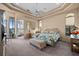 Serene main bedroom featuring a sitting area, en-suite and tray ceilings with a ceiling fan at 5287 61St S Ave, St Petersburg, FL 33715