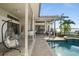 Outdoor living space with a pool, spa, dining, and waterfront view at 5287 61St S Ave, St Petersburg, FL 33715
