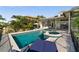 A backyard pool with a hot tub and lounge chairs, perfect for relaxing and enjoying the beautiful sunny weather at 5287 61St S Ave, St Petersburg, FL 33715