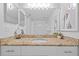 Clean bathroom with granite countertop, framed mirror, and updated decor at 5445 Gulf Blvd # 210, St Pete Beach, FL 33706