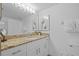 Bathroom featuring white vanity, granite counter, framed mirror and standard toilet at 5445 Gulf Blvd # 210, St Pete Beach, FL 33706