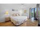 Cozy bedroom with a view of the water, comfortable queen size bed and wicker furnishings at 5445 Gulf Blvd # 210, St Pete Beach, FL 33706