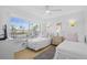 Bright bedroom with twin beds, wicker dresser, and ample natural light from a large window at 5445 Gulf Blvd # 210, St Pete Beach, FL 33706