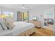 Bright bedroom featuring a queen size bed, deck access, and a calming color palette at 5445 Gulf Blvd # 210, St Pete Beach, FL 33706