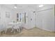 Bright breakfast nook with a white table set next to a window at 5445 Gulf Blvd # 210, St Pete Beach, FL 33706