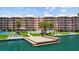 Condo building featuring a tennis court, pool, and boat dock on a sunny day at 5445 Gulf Blvd # 210, St Pete Beach, FL 33706