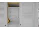 Convenient laundry closet featuring a stacked washer and dryer unit at 5445 Gulf Blvd # 210, St Pete Beach, FL 33706