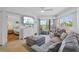 Living room with water view, comfortable seating, and seamless flow to the bedroom at 5445 Gulf Blvd # 210, St Pete Beach, FL 33706