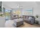 Cozy living room with neutral tones, tile floors, and access to a private balcony at 5445 Gulf Blvd # 210, St Pete Beach, FL 33706