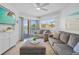 Living room with comfortable seating, balcony access, and stylish decor at 5445 Gulf Blvd # 210, St Pete Beach, FL 33706
