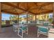 Outdoor pavilion with tables, chairs, and grills at 5445 Gulf Blvd # 210, St Pete Beach, FL 33706