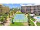 Aerial view of tennis court with tropical landscaping near the beach at 5445 Gulf Blvd # 210, St Pete Beach, FL 33706