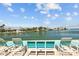Waterfront view with lounge chairs on a deck at 5445 Gulf Blvd # 210, St Pete Beach, FL 33706