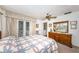 Comfortable bedroom with a ceiling fan, dresser, large window, and exterior doors to backyard at 5919 35Th N Ave, St Petersburg, FL 33703