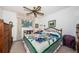 Bright bedroom with a ceiling fan, white walls, large window, and lots of natural light at 5919 35Th N Ave, St Petersburg, FL 33703