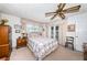 Spacious bedroom features a ceiling fan, window, closet, and an en-suite bathroom at 5919 35Th N Ave, St Petersburg, FL 33703