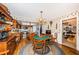 Dining area featuring hardwood floors, floral wallpaper, and adjacent kitchen and Gathering room at 5919 35Th N Ave, St Petersburg, FL 33703