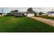 Charming home with lush green lawn, brick-lined driveway, and a well-manicured landscape at 5919 35Th N Ave, St Petersburg, FL 33703
