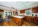 Spacious kitchen with a central island, wood cabinetry, and adjacent dining area with outdoor access at 5919 35Th N Ave, St Petersburg, FL 33703