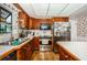Kitchen featuring stainless steel appliances, wood cabinets, and a bright window over the sink at 5919 35Th N Ave, St Petersburg, FL 33703