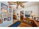 Inviting office area features a ceiling fan, hardwood floors, decoratively painted walls, and entry to other rooms at 5919 35Th N Ave, St Petersburg, FL 33703