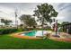 Backyard pool with brick surround and a seating area, shaded by mature trees at 5919 35Th N Ave, St Petersburg, FL 33703