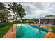 A refreshing pool area with lush greenery and comfortable seating that offers a serene backyard escape at 5919 35Th N Ave, St Petersburg, FL 33703