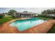 An inviting outdoor pool with a brick border is perfect for relaxation and enjoying the Florida sunshine at 5919 35Th N Ave, St Petersburg, FL 33703