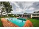A refreshing pool area with lush greenery and comfortable seating that offers a serene backyard escape at 5919 35Th N Ave, St Petersburg, FL 33703