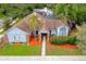Expansive aerial shot of a single Gathering home surrounded by mature landscaping and featuring a brown tile roof at 625 Fayette S Dr, Safety Harbor, FL 34695