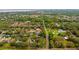 Expansive aerial view of a property surrounded by lush greenery and nearby water features at 625 Fayette S Dr, Safety Harbor, FL 34695