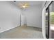 Bedroom features a sliding glass door, a ceiling fan, and access to a walk-in closet at 625 Fayette S Dr, Safety Harbor, FL 34695