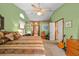 Comfortable bedroom with ceiling fan, bright green walls, and ample closet space at 625 Fayette S Dr, Safety Harbor, FL 34695