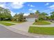 Charming home with a two-car garage, a well-maintained lawn, and mature trees at 625 Fayette S Dr, Safety Harbor, FL 34695