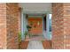Inviting front entrance with brick detailing and vibrant orange double doors to welcome guests at 625 Fayette S Dr, Safety Harbor, FL 34695