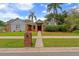 Charming home featuring manicured lawn, a brick mailbox, and a welcoming entrance at 625 Fayette S Dr, Safety Harbor, FL 34695