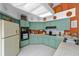 Charming kitchen features appliances, ample cabinet space, and tile floors at 625 Fayette S Dr, Safety Harbor, FL 34695