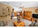 Spacious living room featuring a ceiling fan, ample seating, and natural light at 625 Fayette S Dr, Safety Harbor, FL 34695