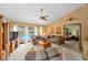 Bright living room featuring a ceiling fan, backyard views, and access to an adjacent bedroom at 625 Fayette S Dr, Safety Harbor, FL 34695