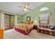 Cozy main bedroom features a ceiling fan, patio access, and natural lighting at 625 Fayette S Dr, Safety Harbor, FL 34695
