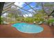 Large screened-in pool with ample seating and lush landscaping for privacy at 625 Fayette S Dr, Safety Harbor, FL 34695