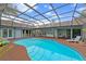Inviting screened-in pool area with ample seating, creating a perfect outdoor entertaining space at 625 Fayette S Dr, Safety Harbor, FL 34695
