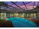 A serene screened-in pool offers a tranquil escape with ample lounge space and outdoor amenities at 625 Fayette S Dr, Safety Harbor, FL 34695
