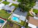 Aerial view of a landscaped property featuring a private pool and enclosed backyard at 6920 13Th N Ave, St Petersburg, FL 33710