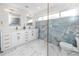 Contemporary bathroom features a dual vanity, marble tile flooring, glass-enclosed shower, and blue accent tile at 6920 13Th N Ave, St Petersburg, FL 33710