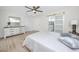 Neutral bedroom featuring light wood flooring, light walls, and an ensuite bathroom at 6920 13Th N Ave, St Petersburg, FL 33710